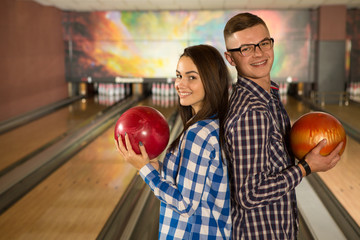 Beautiful happy couple bowling together at the local club