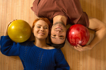 Fototapeta premium Beautiful happy couple bowling together at the local club