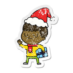 distressed sticker cartoon of a grumpy boy wearing santa hat