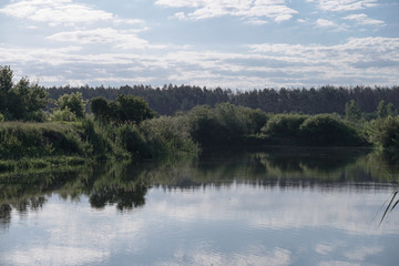 Pretty river in rural areas. European landscape of Russia and Siberia. Beautiful tranquil view of nature. Stock background, photo.