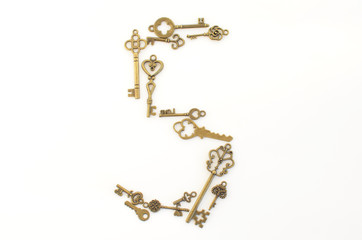 Decorative keys of different sizes, stylized antique on a white background. Form the centerpiece. Numeral
