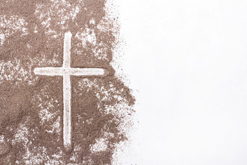Cross and ash on white background - symbol of Ash Wednesday. Copy space