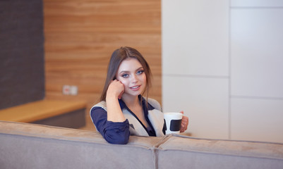 beautiful girl resting on a chic couch