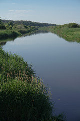 Pretty river in rural areas. European landscape of Russia and Siberia. Beautiful tranquil view of nature. Stock background, photo.