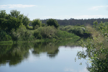 Pretty river in rural areas. European landscape of Russia and Siberia. Beautiful tranquil view of nature. Stock background, photo.