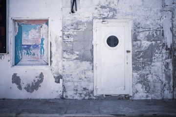old wall with door and nailed window. Interesting structures and colors in a vintaged look