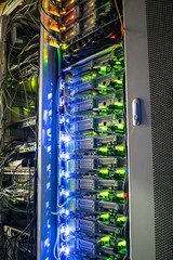  Technical site of the telecommunication Internet provider. Vertical racks with modern computer equipment are in the server room datacenter. The concept of information technology.