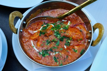 Indian fish curry served in a copper kadahi (karahi)