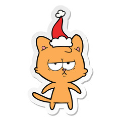 bored sticker cartoon of a cat wearing santa hat