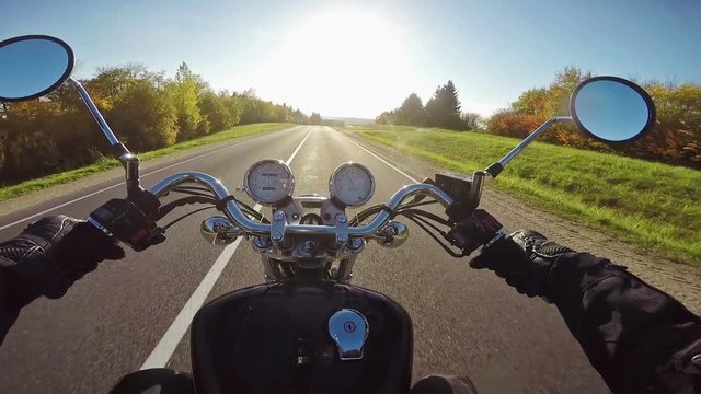 Amazing motorcycle riding towards sun in evening. Classic cruiser/chopper forever! 