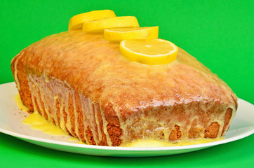 Sweet Lemon Glaze spread over fresh pound cake with sliced lemons on top