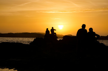 People enjoying the sunset at Essaouira beach in Morocco