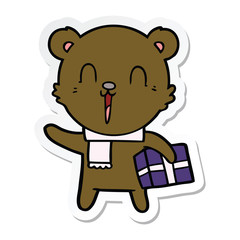 sticker of a happy cartoon bear with gift