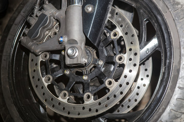 Brake disc on the front wheel of a motorcycle.