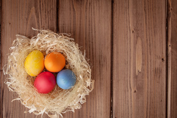 Colorful Easter eggs on wooden background with copy space