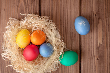 Fototapeta na wymiar Colorful Easter eggs on wooden background with copy space