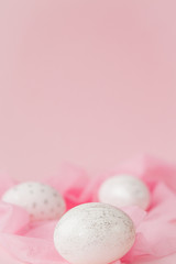 White Easter eggs on pink background with copy space. Top view shot of arrangement decoration Happy Easter holiday background concept. Design pastel tone in minimal flat lay