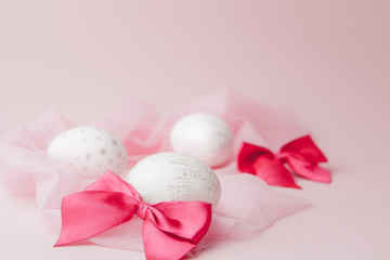 White Easter eggs on pink background with copy space. Top view shot of arrangement decoration Happy Easter holiday background concept. Design pastel tone in minimal flat lay