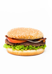 Typical American fast food Hamburger homemade with pan fried ground beef meat patty, lettuce, tomato, onion and bacon in sesame seed bun, so called BLT Burger, isolated on white background, copy space