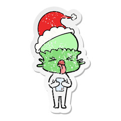 disgusted distressed sticker cartoon of a alien wearing santa hat