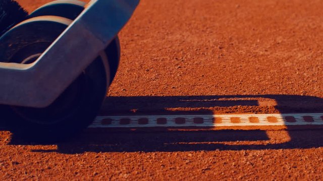Tennis court maintenance Clean clay court lines with machine. 4k, slow motion 75fps