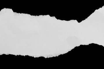 Ripped paper on black background, space for advertising copy.