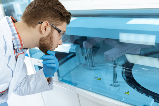 Young handsome laboratory technician working at the modern medical lab