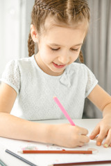Cute little girl studying at school