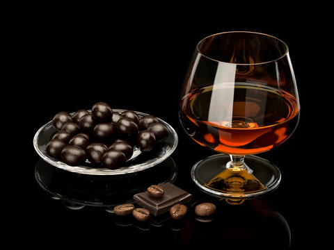 Cognac In Glass And Chocolate Covered Coffee Beans