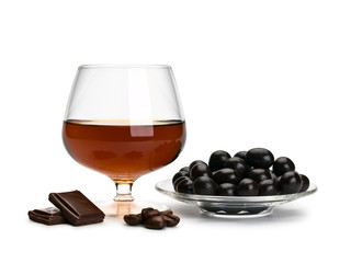 Cognac in glass and chocolate covered coffee beans