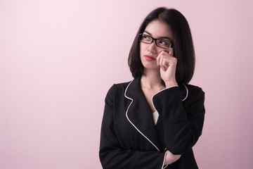 Cute asian woman thinking and imagination isolated on pink background