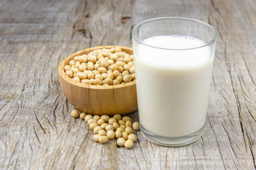 soy milk with soybean on wooden background.