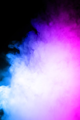 Fototapeta na wymiar Сlouds of vape fog on black background. At right side thick smoke rising up. Bicolor blue and purple steam in frame. Vape culture and no smoking direction..