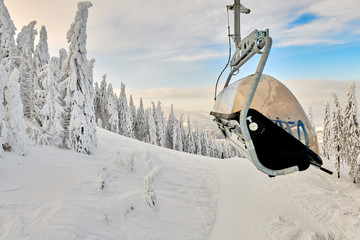 Chair lift in Poiana Brasov ski resort, Skiers and snowboarders enjoy the ski slopes in Poiana...