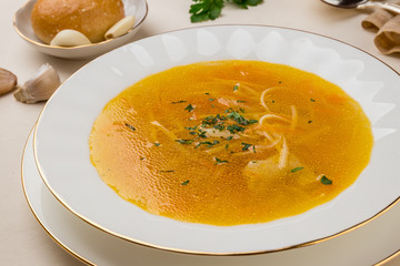 Chicken soup bouillon in a plate