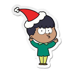 sticker cartoon of a curious boy wearing santa hat