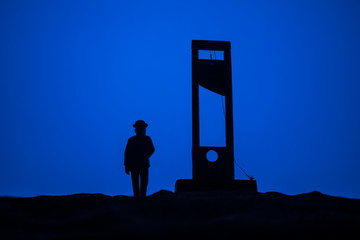 Horror view of Guillotine. Close-up of a guillotine on a dark foggy background.
