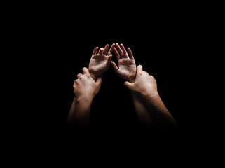 Man hands holding a woman hands for rape and sexual abuse concept isolated on black background - obrazy, fototapety, plakaty