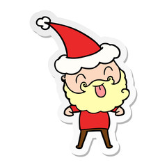 man with beard sticking out tongue wearing santa hat