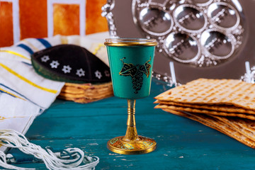 Passover jewish day matzoh and kosher wine over wooden table.