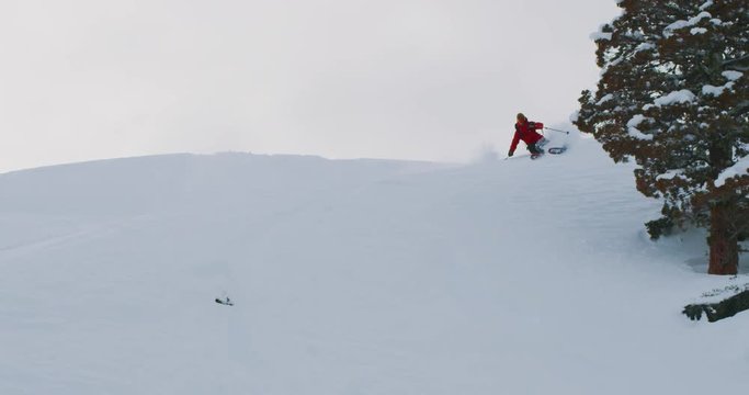 Skier doing smooth turns in powder, fun backcountry skiing, slow motion