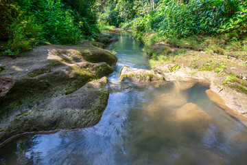 Fototapeta premium The river flows against the background of rock