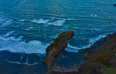 Historical landmark Battle Rock in Port Orford, Oregon, aerial drone shot