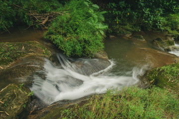 The river flows against the background of rock