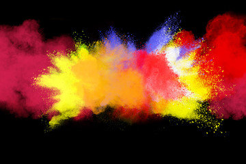 abstract colored dust explosion on a black background.abstract powder splatted background,Freeze motion of color powder exploding/throwing color powder, multicolored glitter texture. 