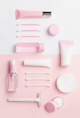 Naklejka premium Face care products (tonic or lotion, serum, cream, micellar water, cotton pads and sticks, shaver) on powder background. Freshness and body care. Skin care and anti-age care. Top view diagonal layout