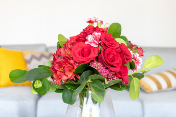 Arrangement of roses and red carnations
