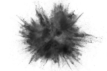 Black powder explosion against white background. Charcoal dust particles exhale in the air. - obrazy, fototapety, plakaty