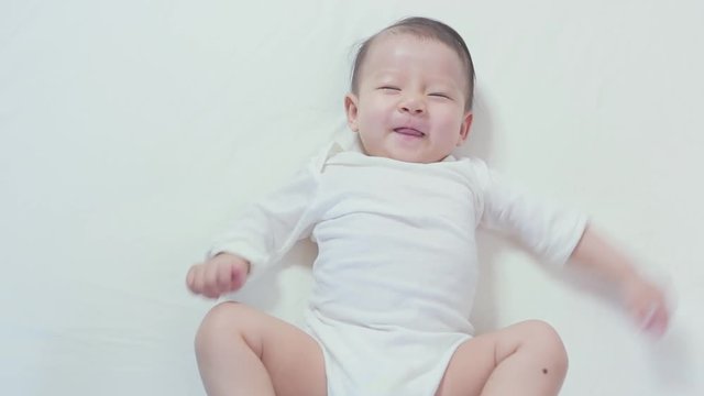 Newborn slepping and playing on the bed, New family and mom protection concept