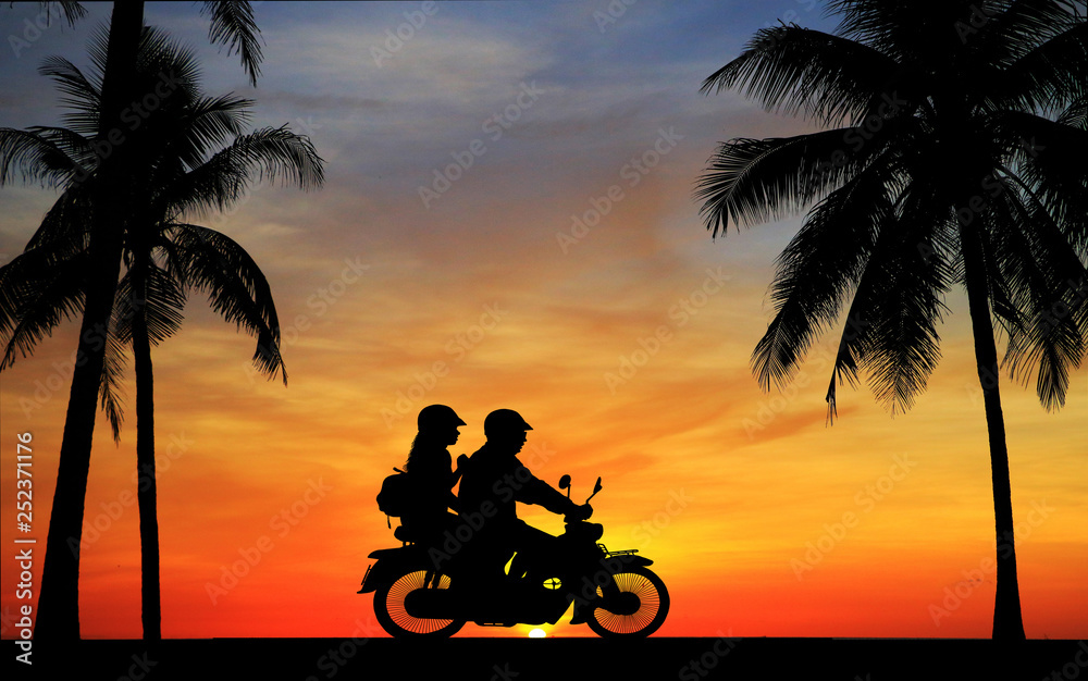 Wall mural silhouette of lover couple in sunset with classic motorcycle